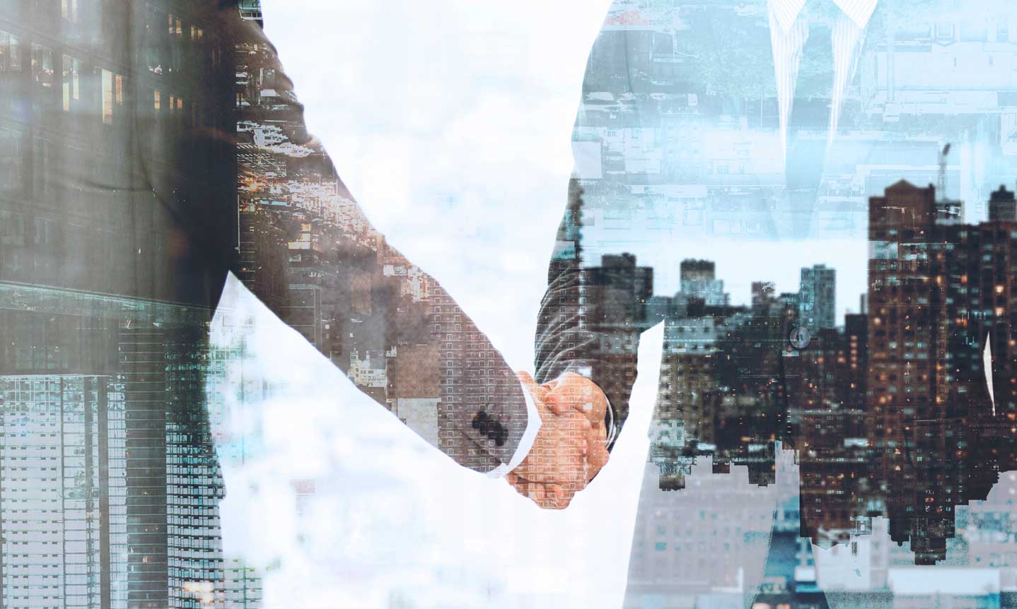 A handshake in double exposure with a city skyline, deal and skyline woven together.
